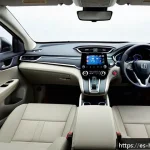 혼다 CR V 하이브리드의 최신 연비 리뷰 - A modern and spacious Honda CR-V hybrid interior viewed from the rear seats, showcasing soft-touch m...